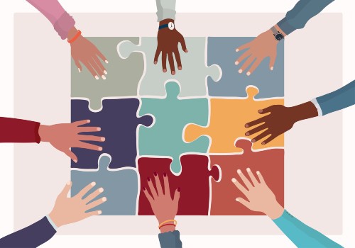 several hands puzzle pieces to create a finished puzzle