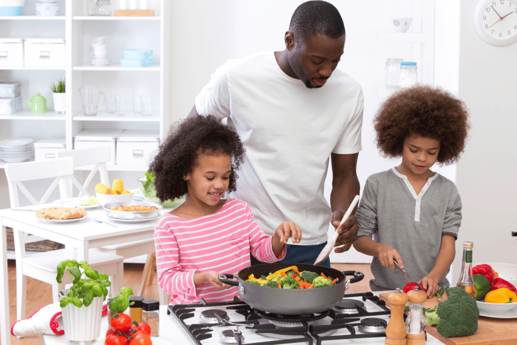 a father teaching his two children how to cook and enjoy heart healthy food